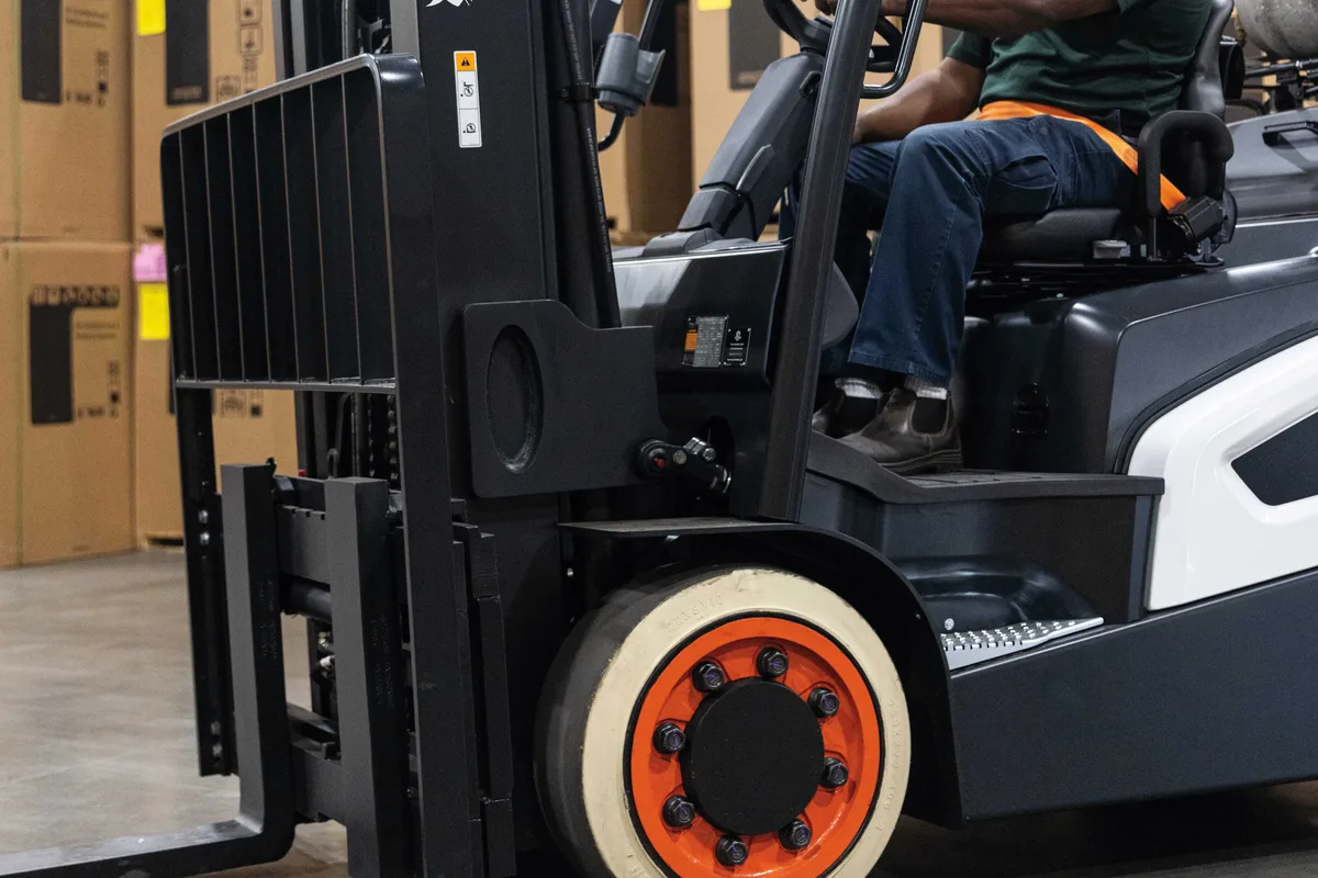Operator at the controls of a Bobcat forklift