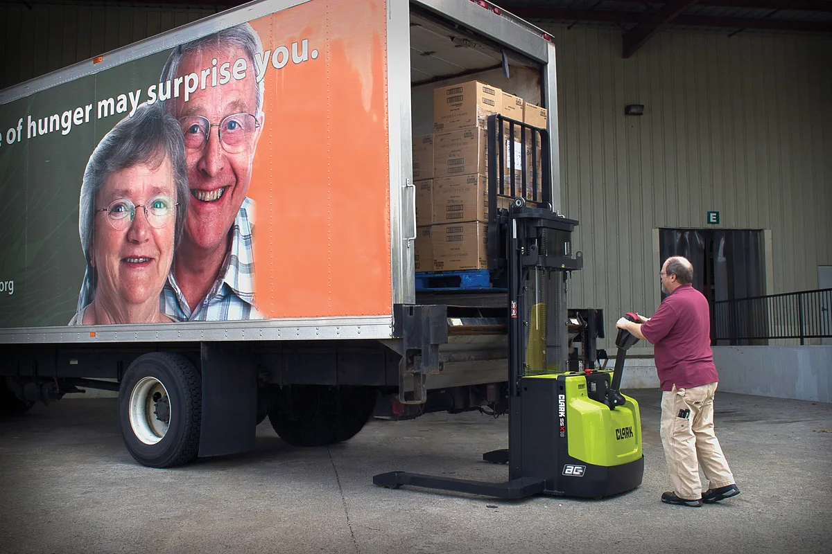 Clark walkie stacker loading a box truck at ground level