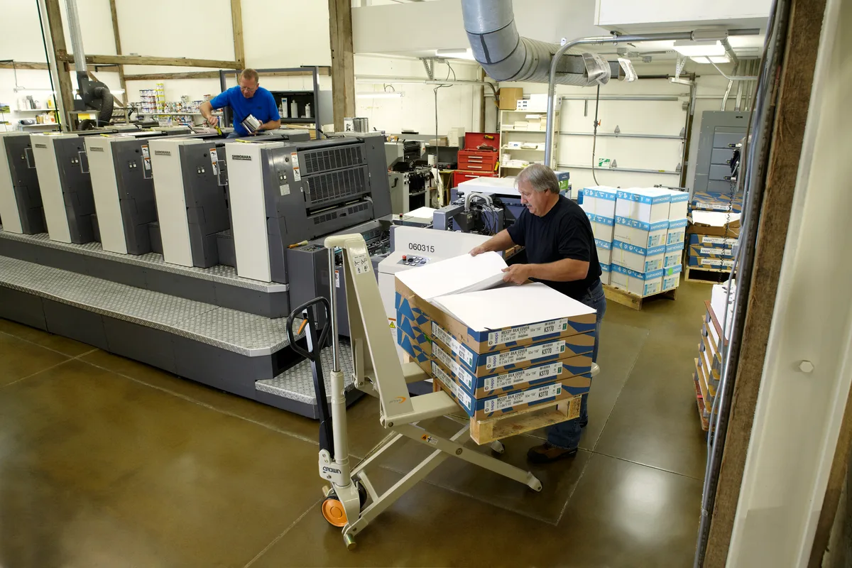 Crown powered pallet truck moving stock in a production facility