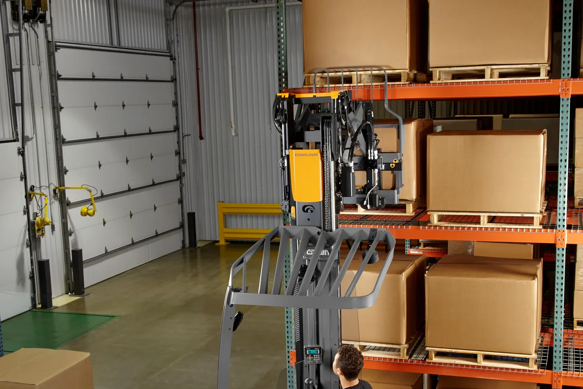 Crown reach truck working a narrow racking aisle