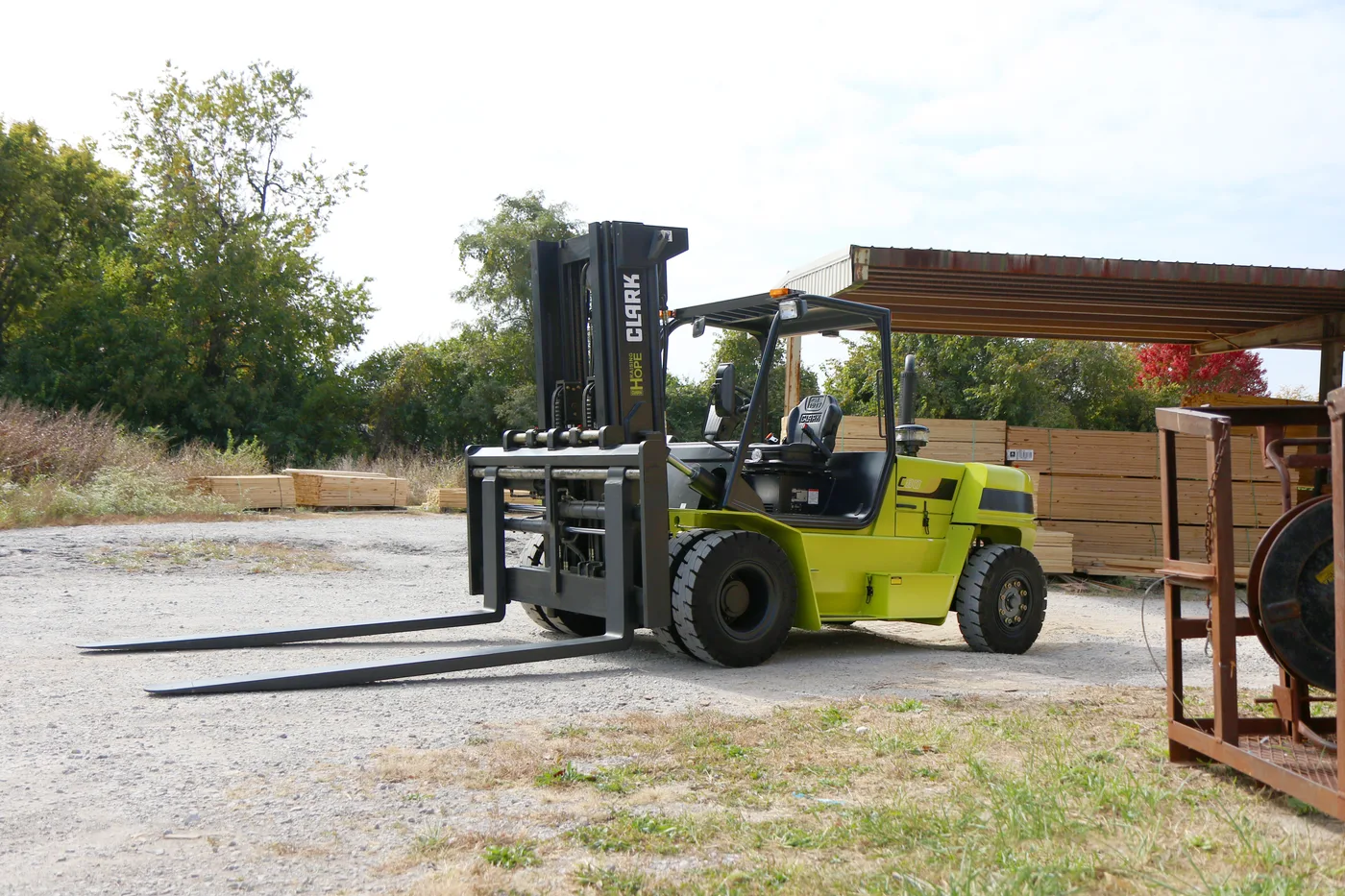 Used pneumatic-tire forklift being inspected before purchase