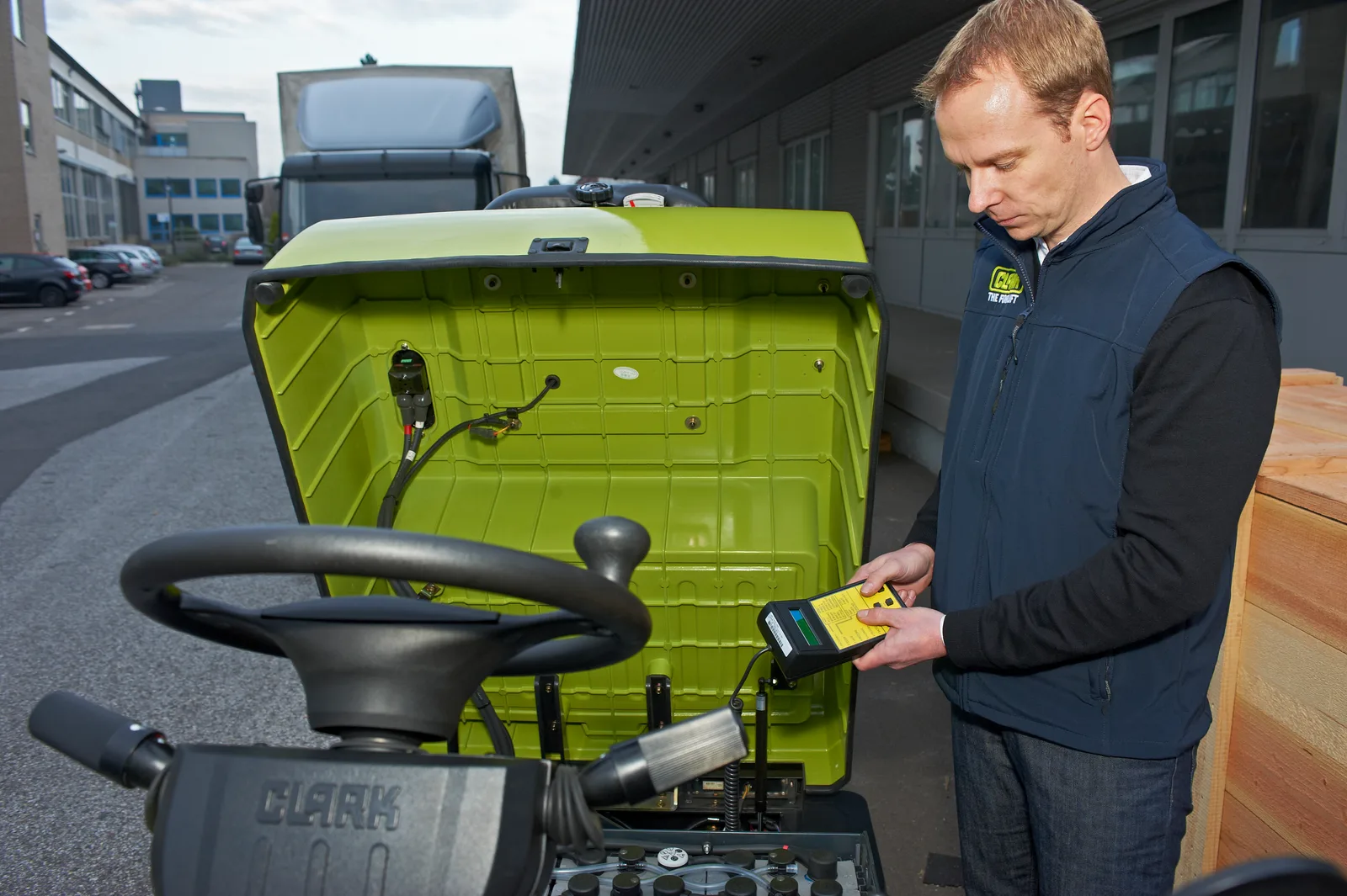 Technician servicing a forklift on site